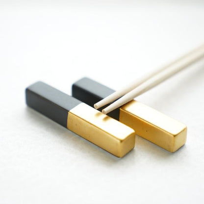 Pair of matte black and gold Arita cutlery rests