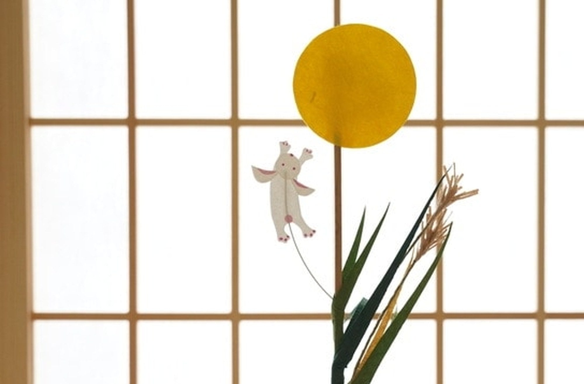Harvest moon pick with rabbit and pampas grass against a shoji screen